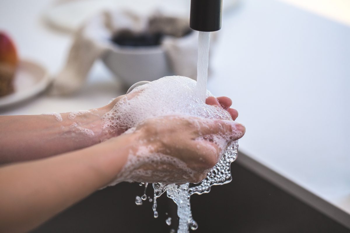 A person washing their hands with soap.
