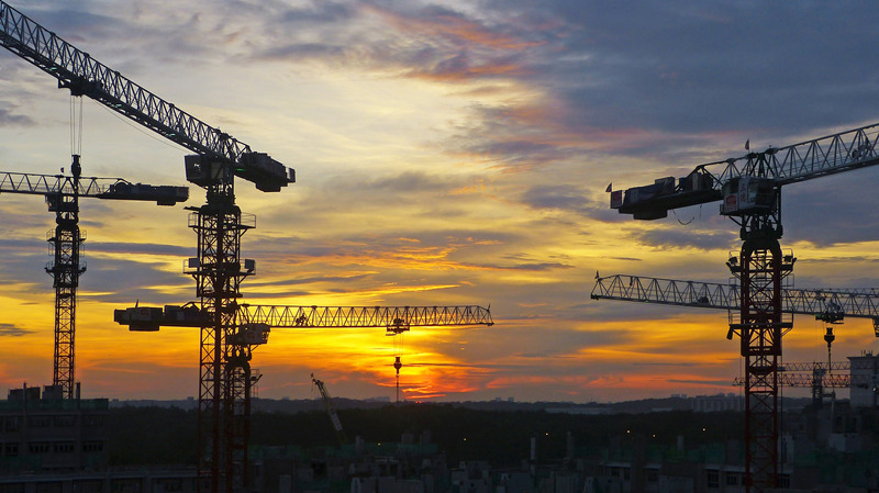 Scaffolding with the sun setting in the background.