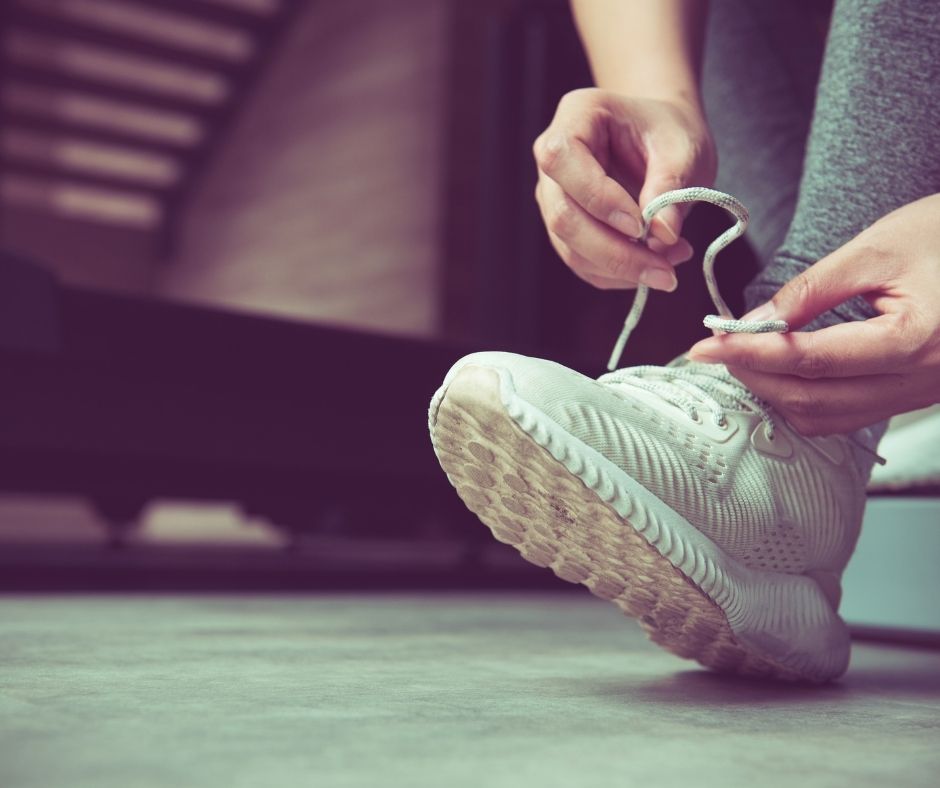 Close up of hands tying the laces on a trainer