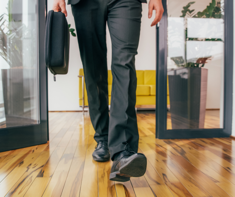 Close-up of a mans legs as he walks into an office