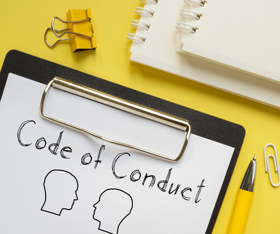 Code of conduct written on a clipboard with two face icons