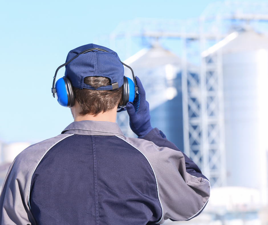 Man wearing blue hearing protection headphones 