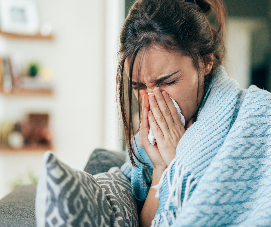 woman with a cold blowing nose