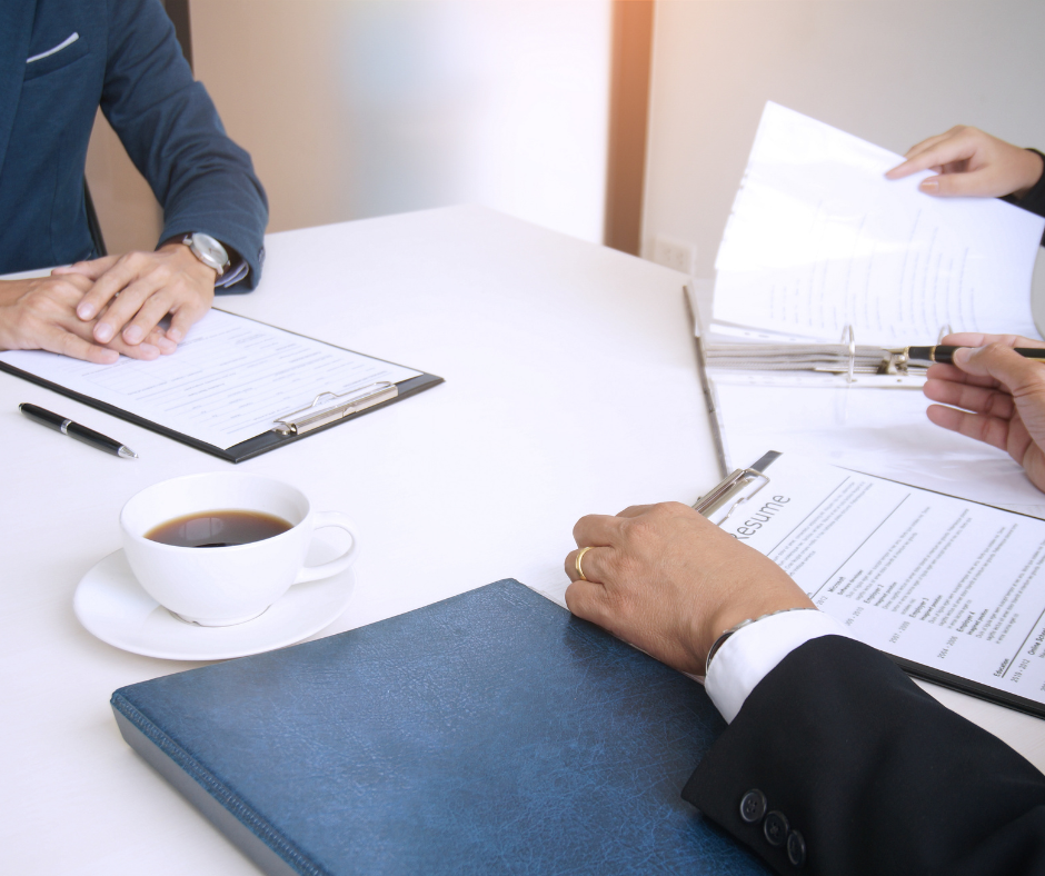 Two people in a meeting with papers
