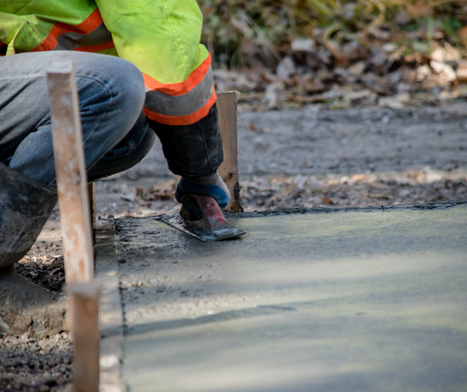 worker laying wet cement